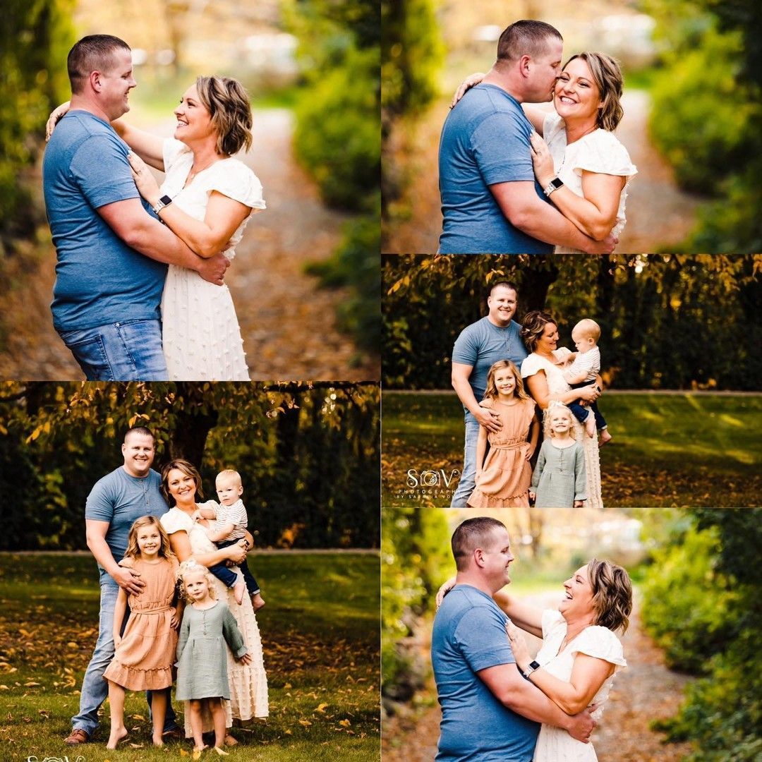Couple and children posing outdoors. Man and woman embrace, smile. Family portrait in a park.