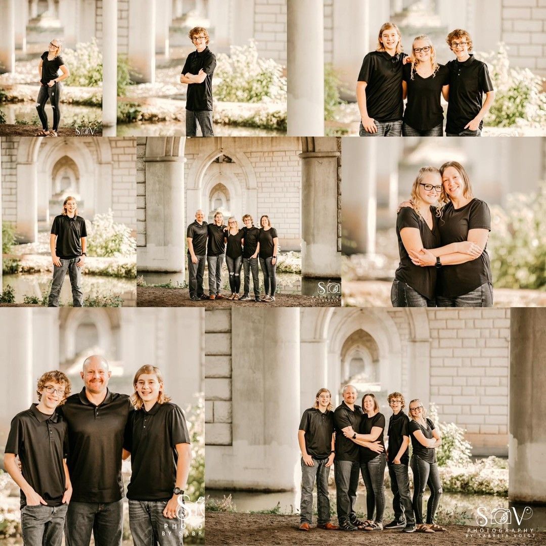Family portraits under a stone arch. People in black shirts and jeans stand and embrace.