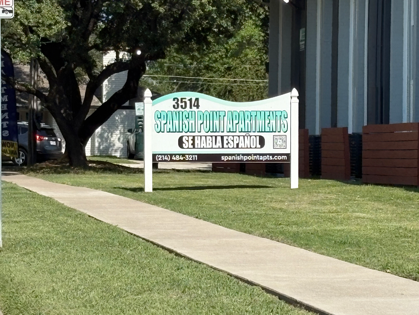 Sign for Spanish Point Apartments; green and white, 
