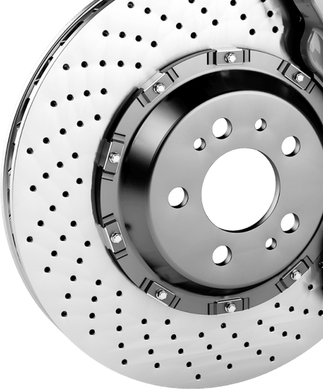Drilled silver car brake rotor. | Strong's Alignment Service