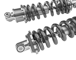 Two shiny silver and black shock absorbers, likely for a vehicle, with coiled springs. | Strong's Alignment Service