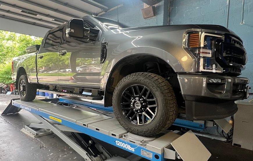 auto repair team standing in garage | Oscar's Automotive