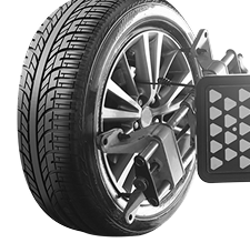 Car tire with wheel alignment equipment attached. | Strong's Alignment Service