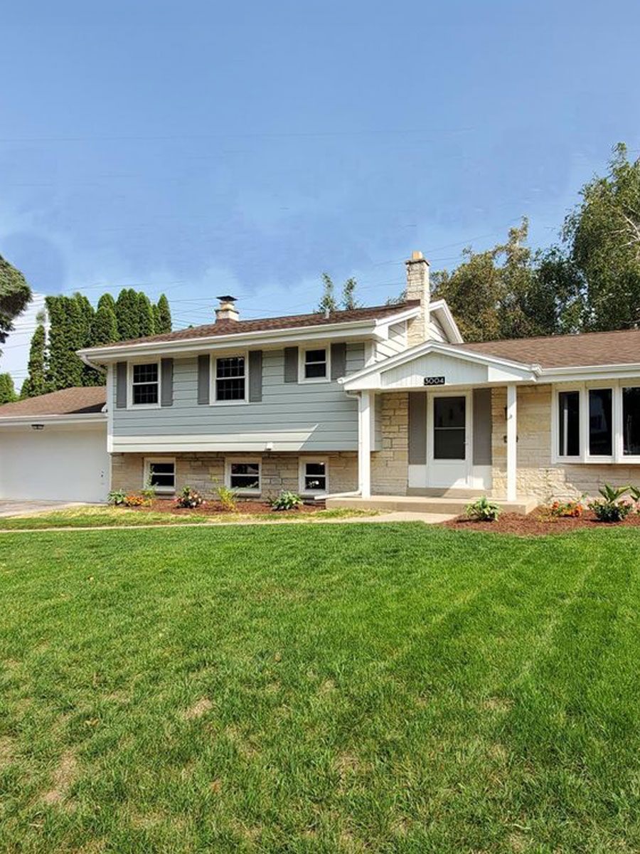 A large house with a large lawn in front of it.