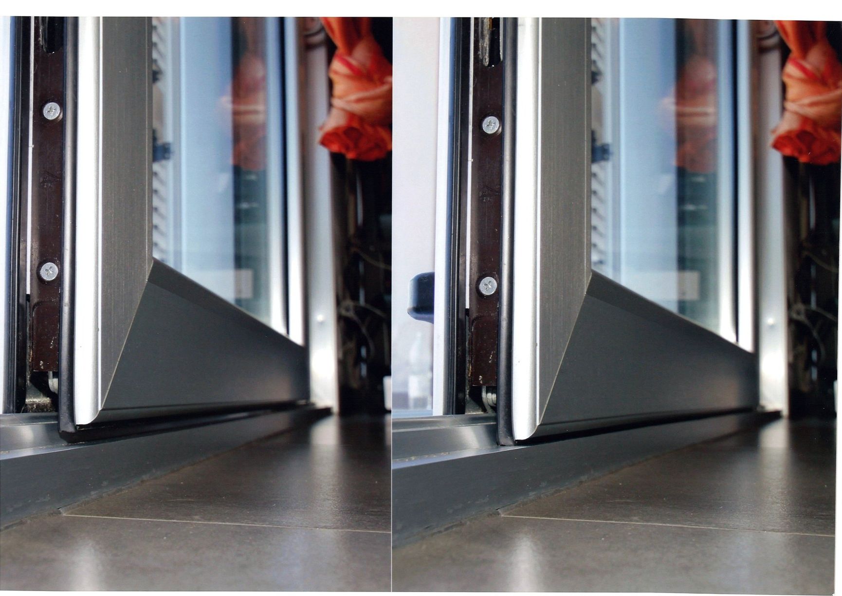 Primo piano del telaio di una finestra con finiture grigio scuro. La finestra è parzialmente aperta.