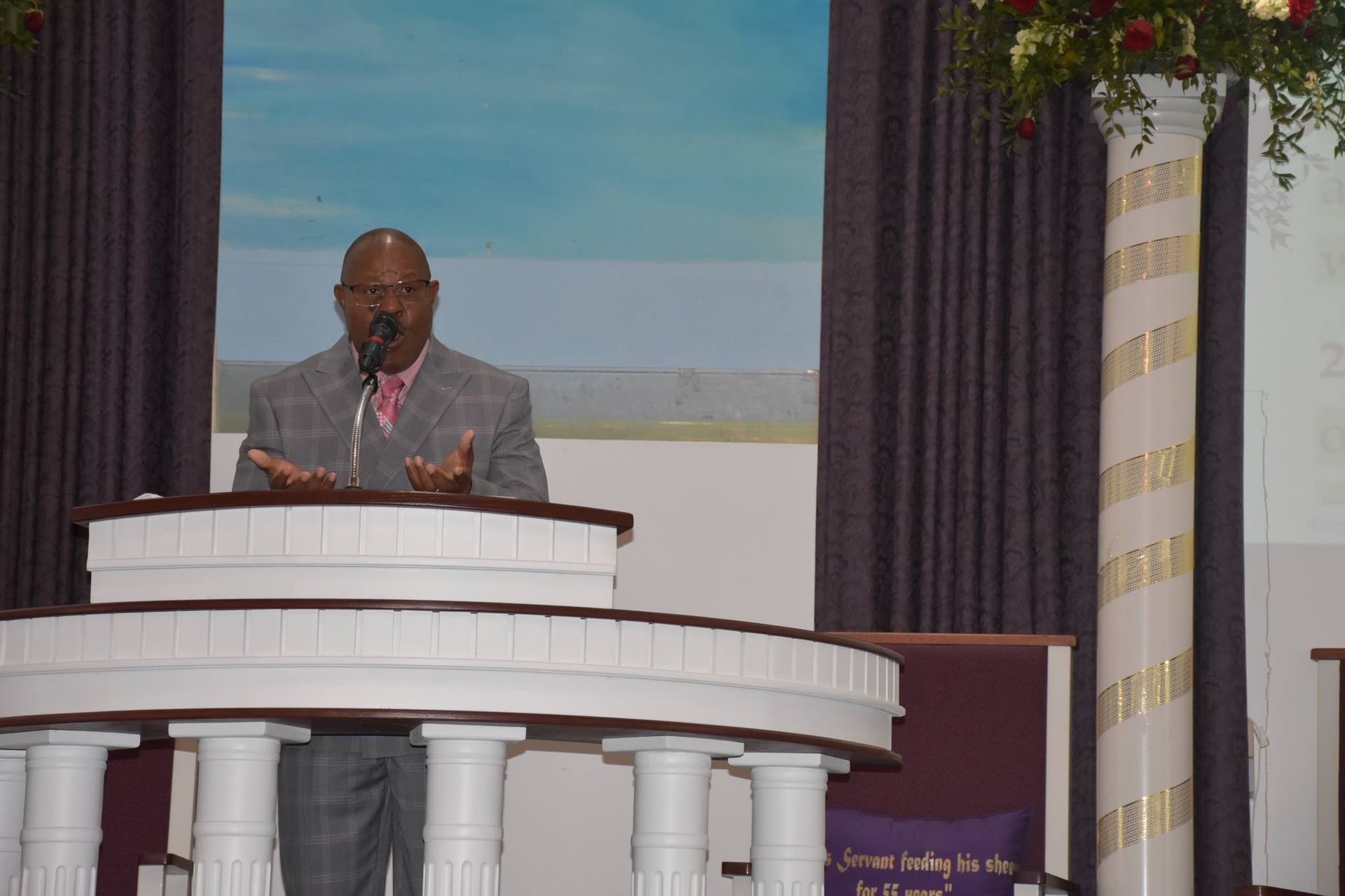 A man is giving a speech at a podium in a church