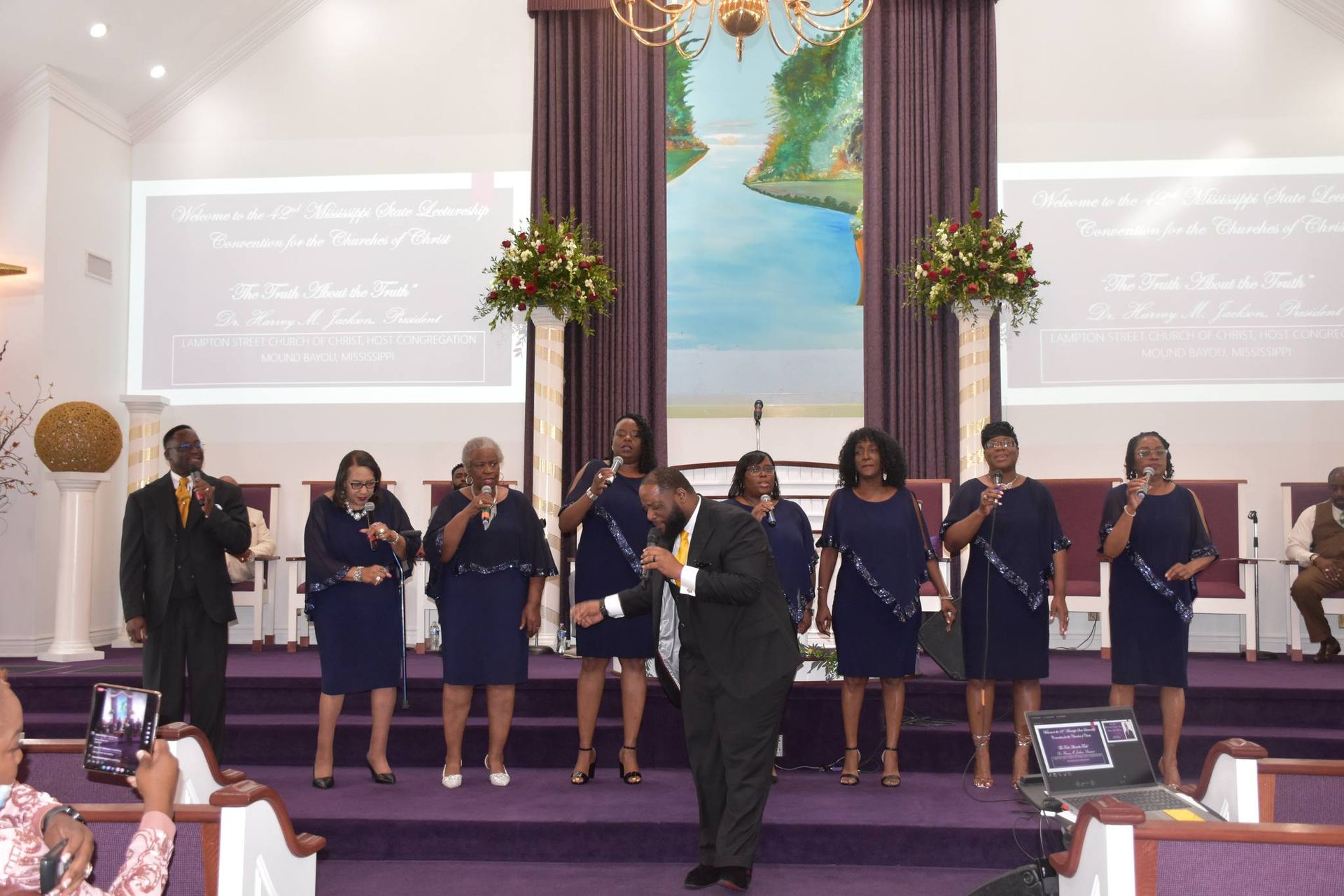 A large group of people are sitting in a church.
