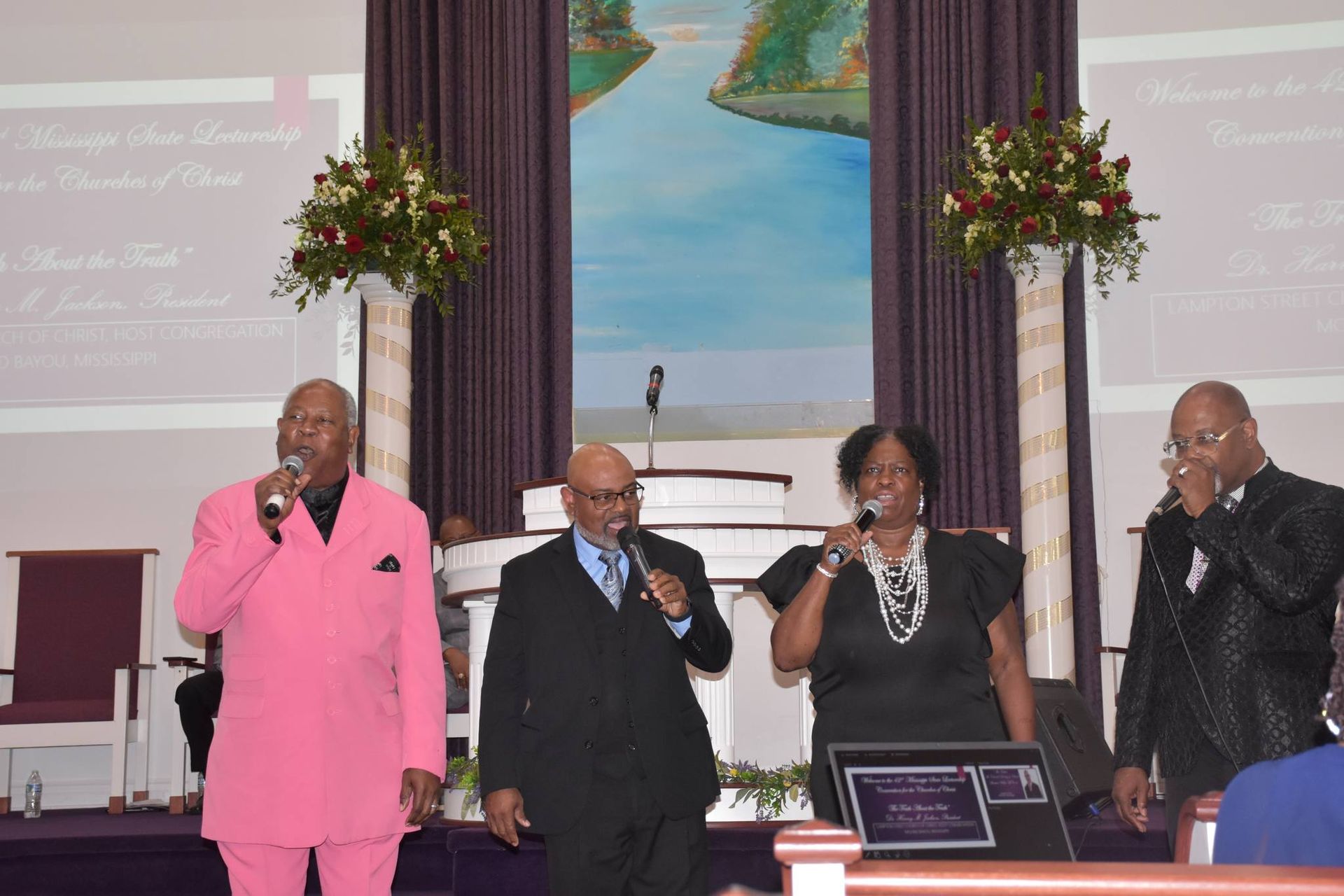 A group of people are singing into microphones in a church.
