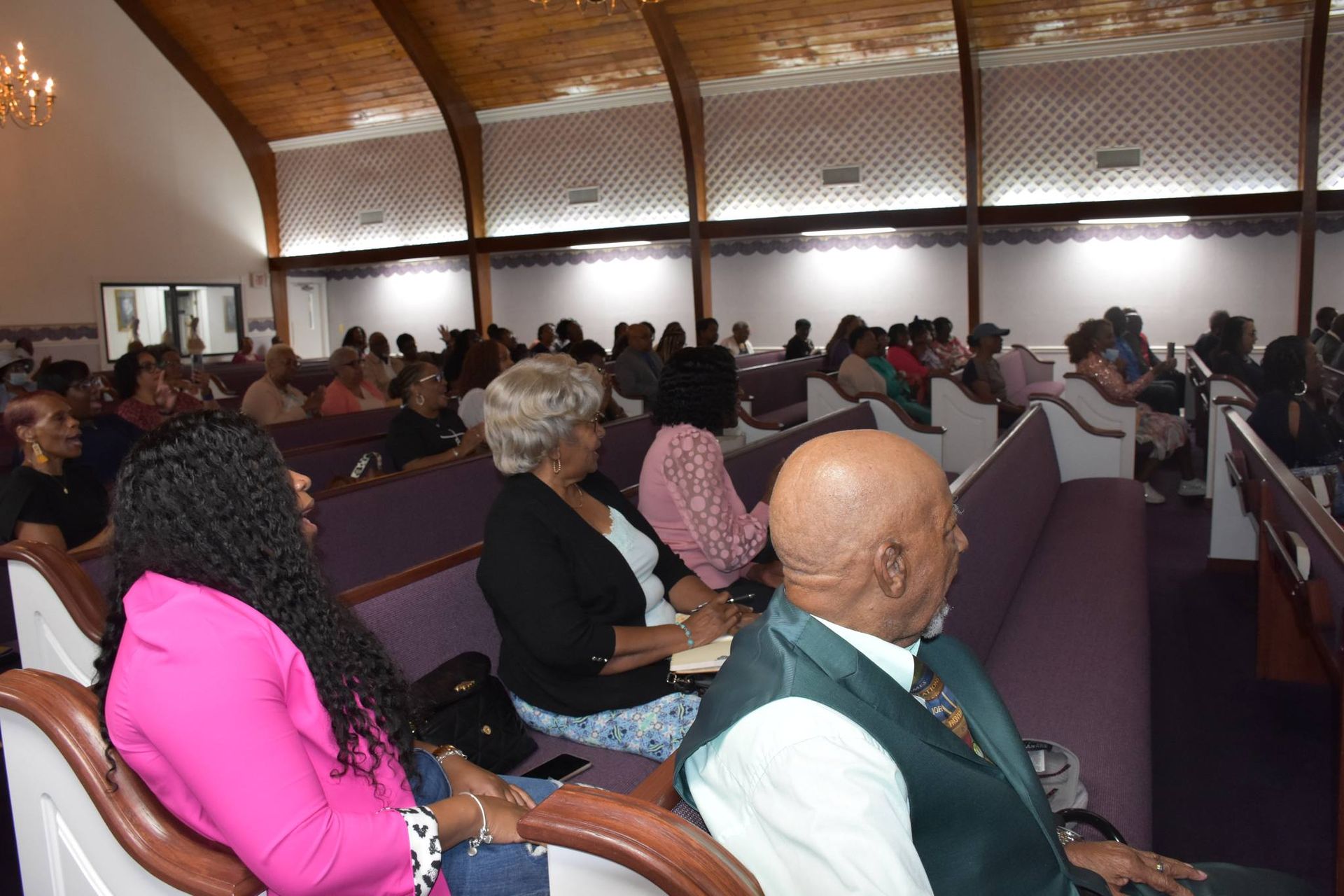 A group of people are sitting in a church.