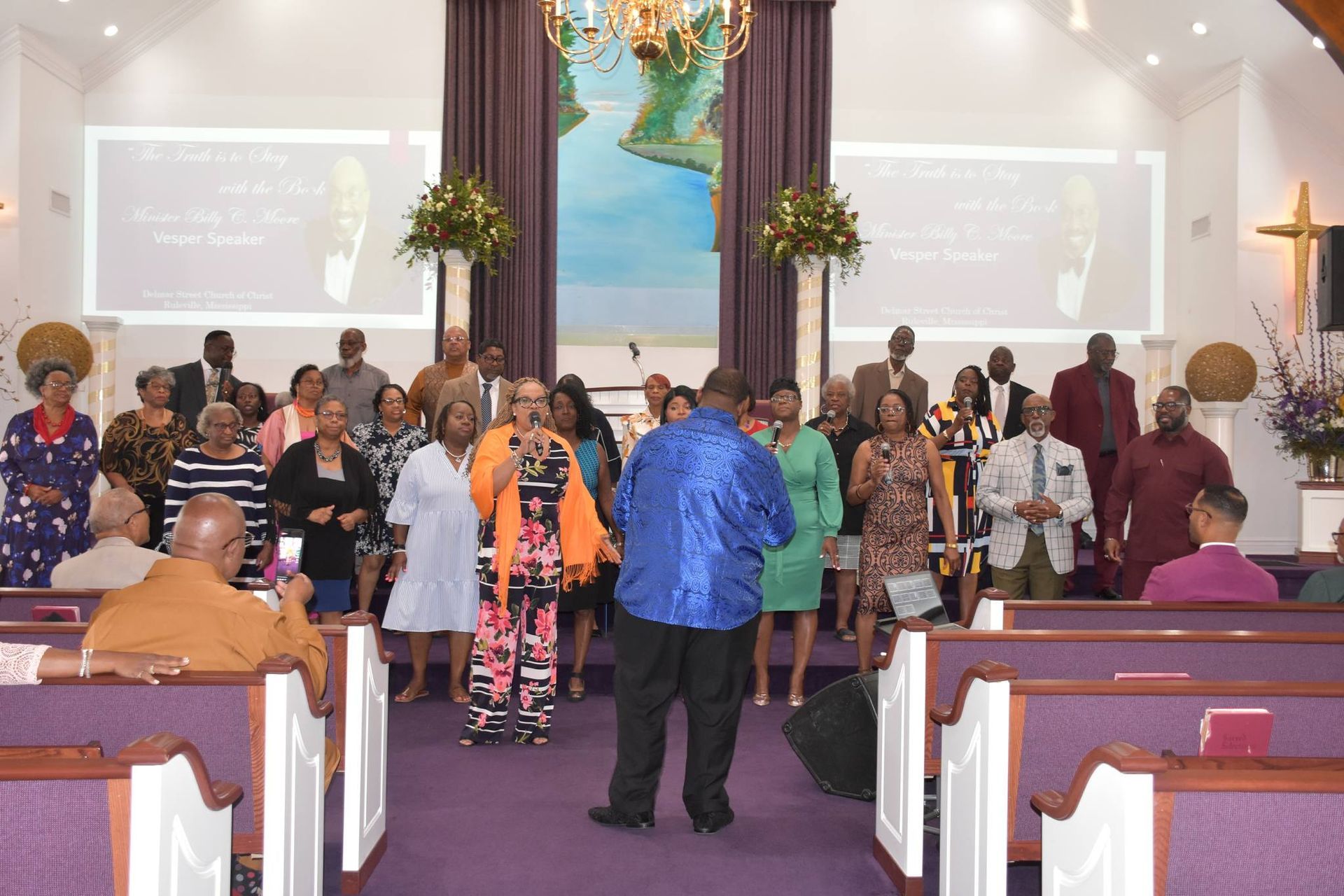 A group of people are posing for a picture in a room.