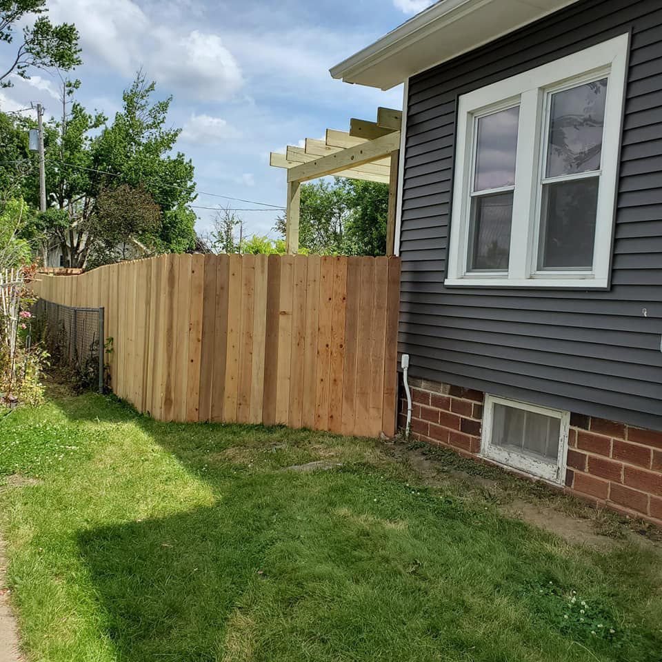 A house with a wooden fence in front of it