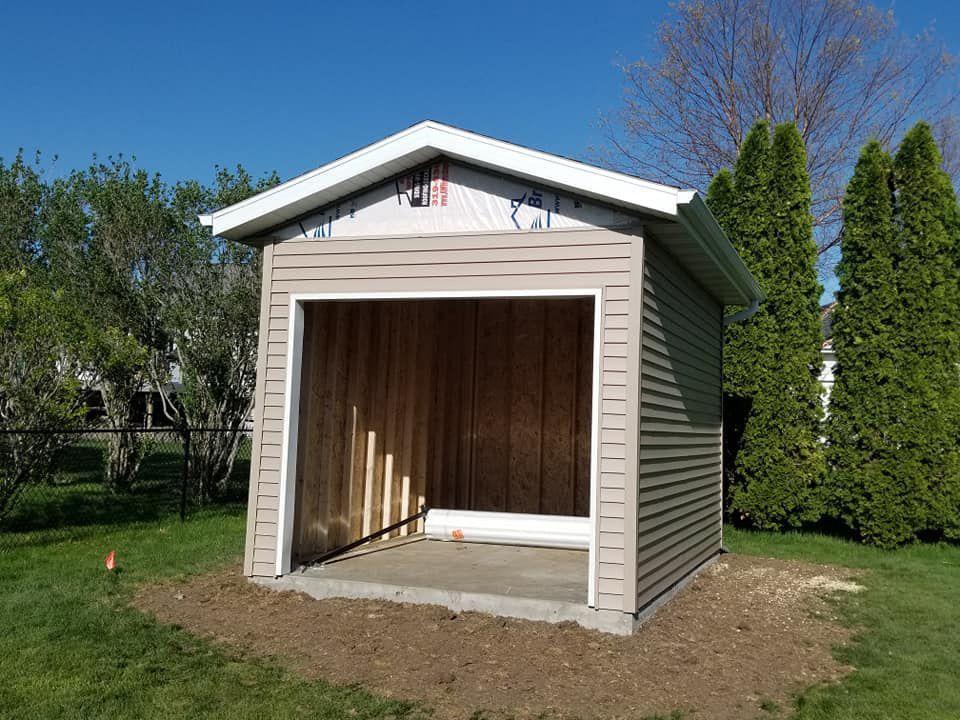 A small shed is being built in a backyard.