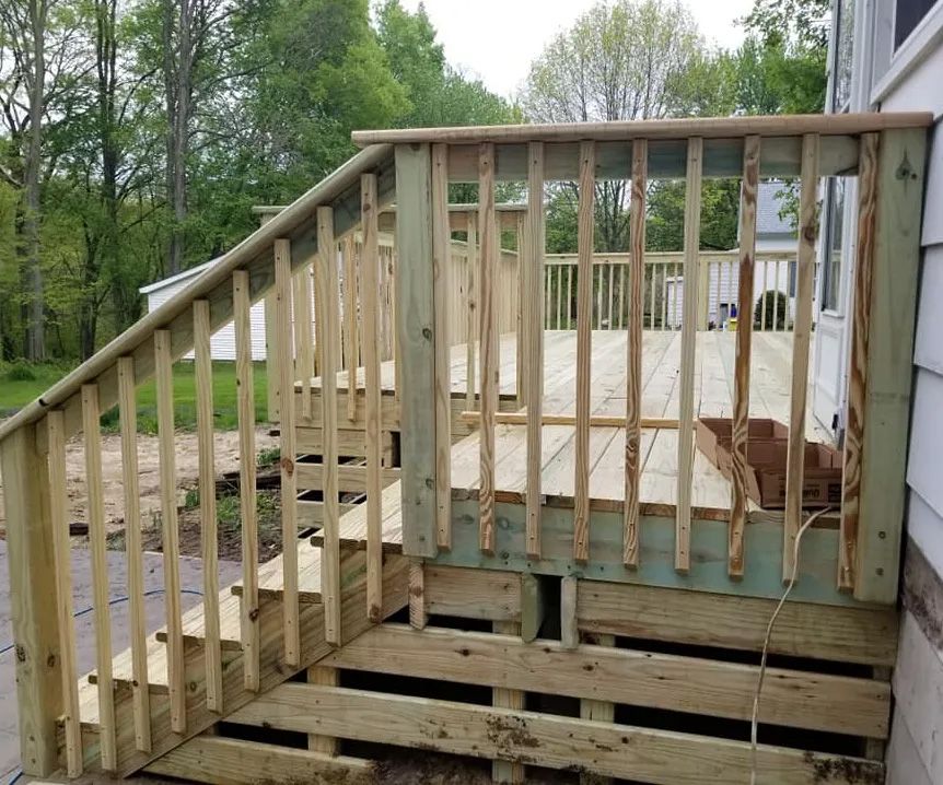 A wooden deck with stairs leading up to it