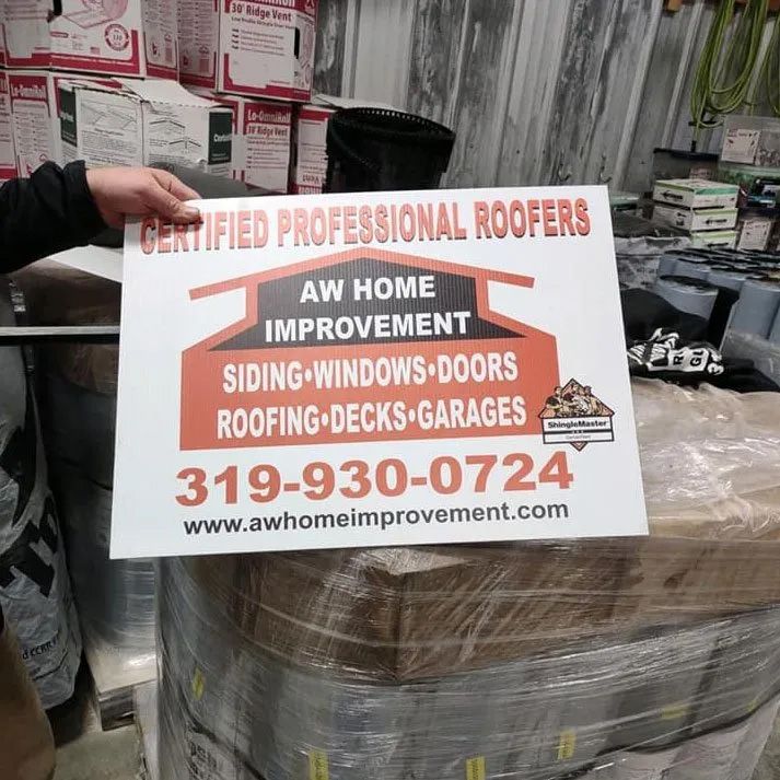 A person is holding a sign for aw home improvement