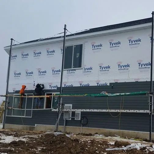 A house is being built with tyvek siding on the side.