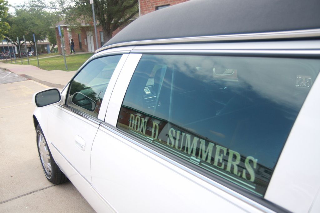 A white limousine with the name don d. summers on the window