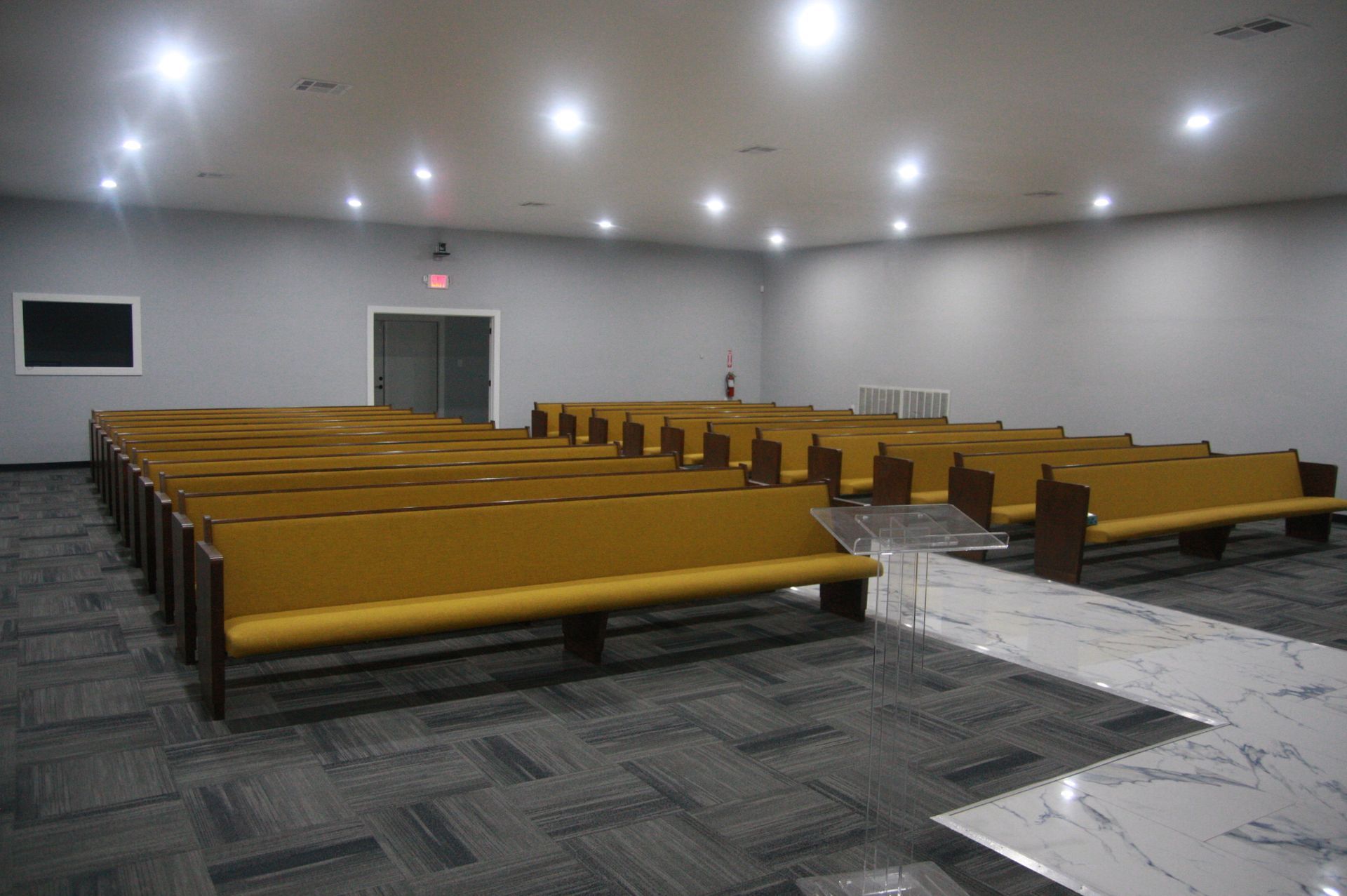 A large room with rows of benches in it
