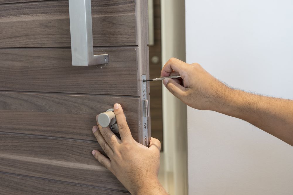 A Close-Up of a Door With a Gold Door Handle and Lock — Total Security Locksmiths in Hope Island, QLD