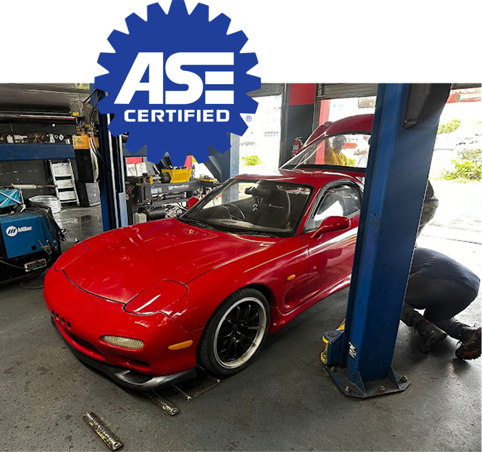 Red sports car in a repair shop. | King Mufflers