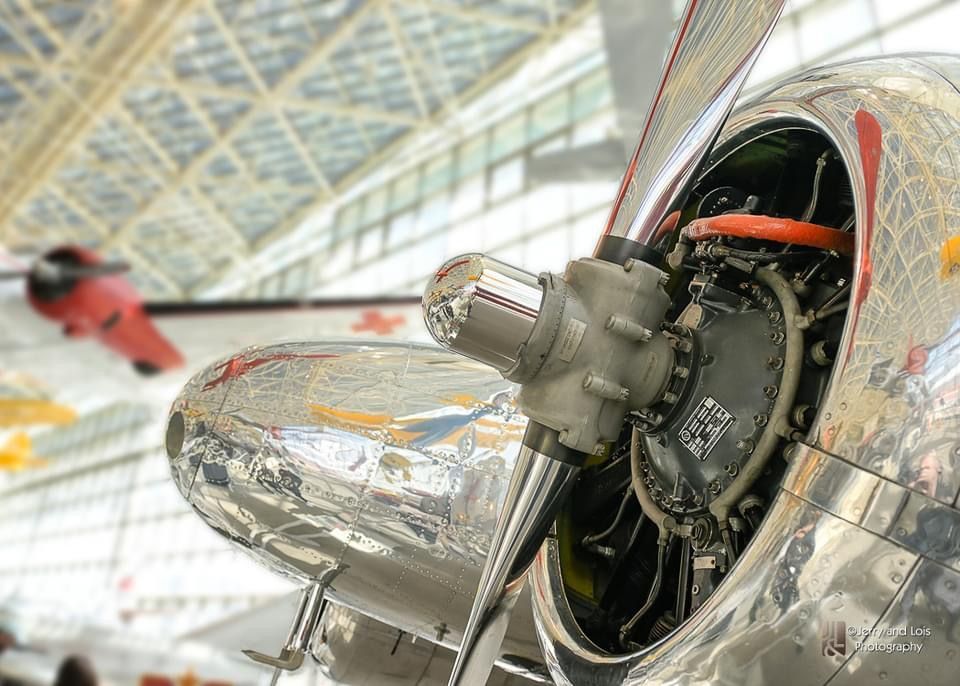 A close up of a propeller on a silver airplane
