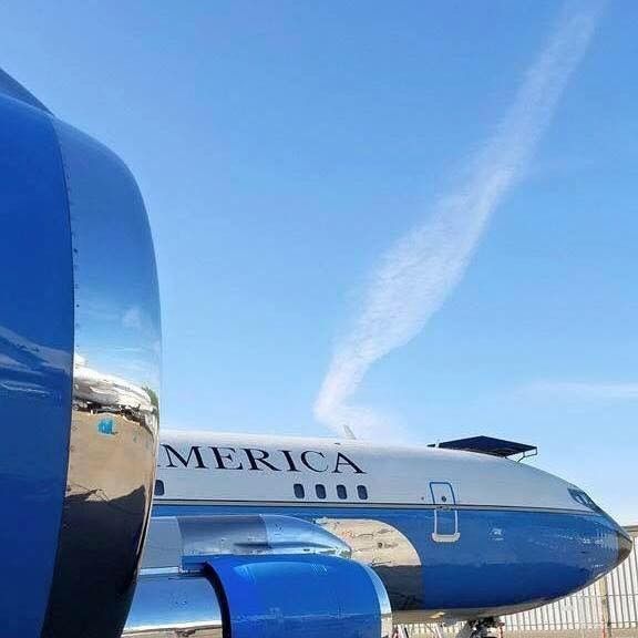 A blue and white airplane with the word merica on it