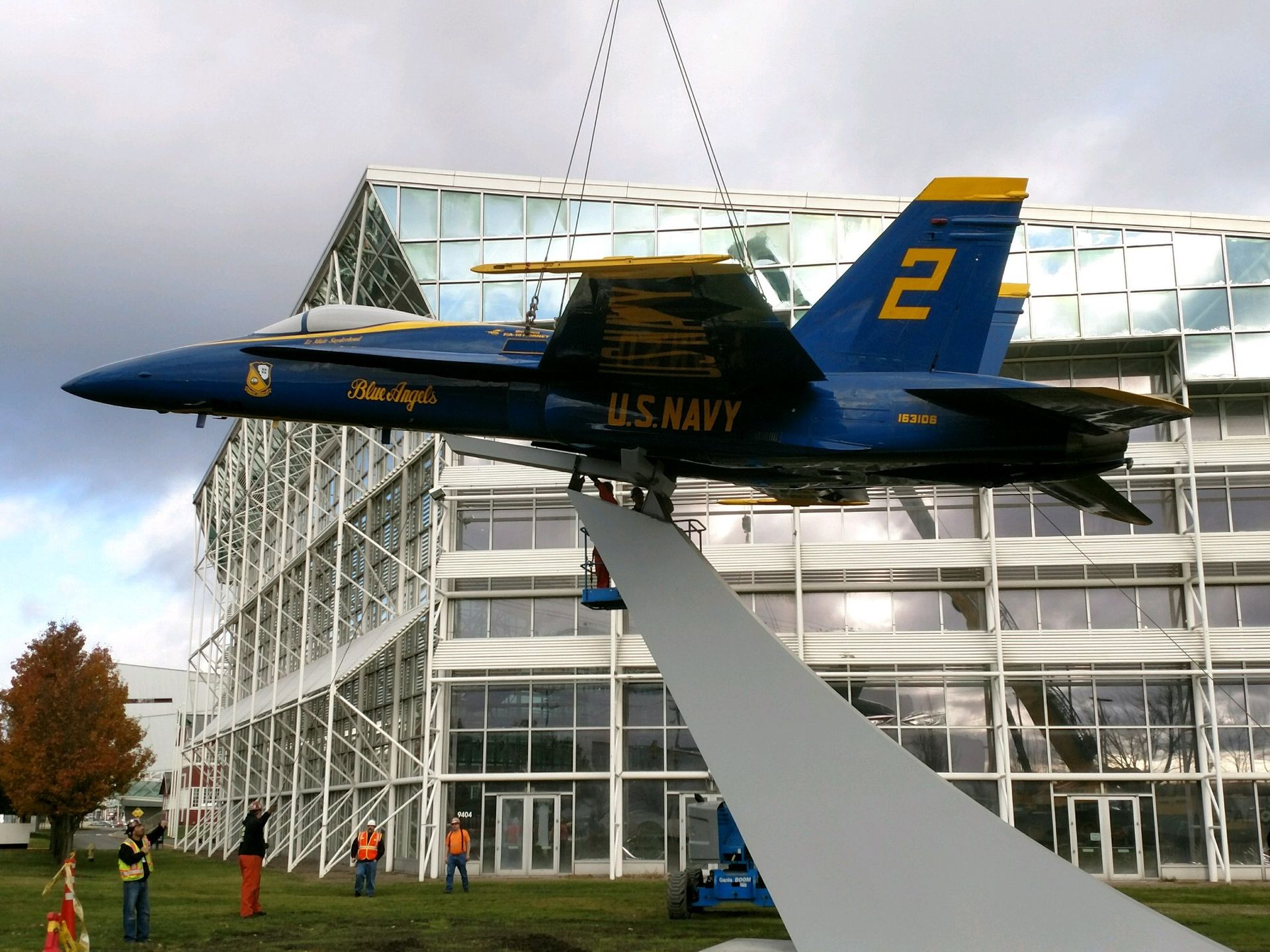 A u.s. navy fighter jet is being lifted into the air