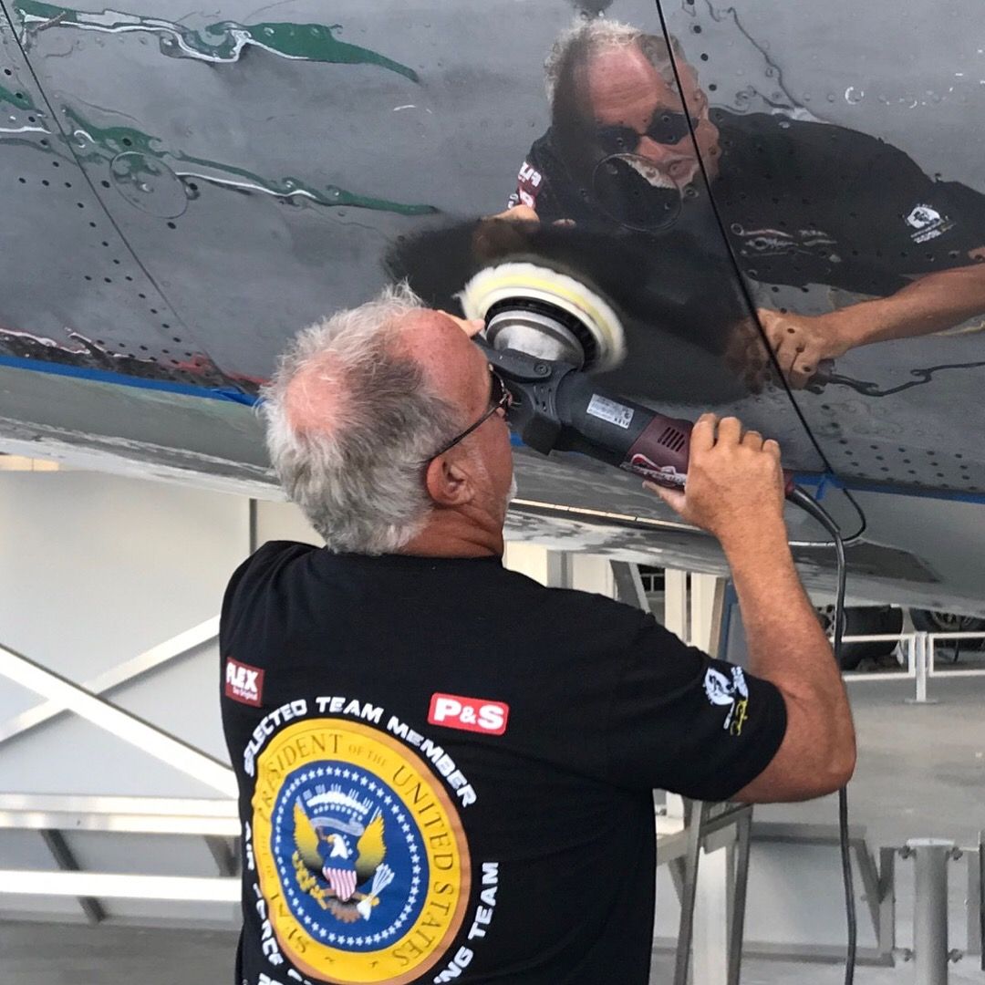 A man wearing a black shirt that says arctic team on the back