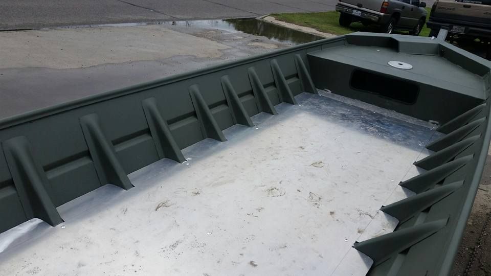 Green and silver aluminum jon boat, empty interior.