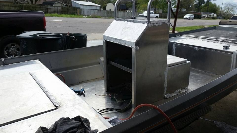 Aluminum boat interior with a central console, unfinished. Outdoors.