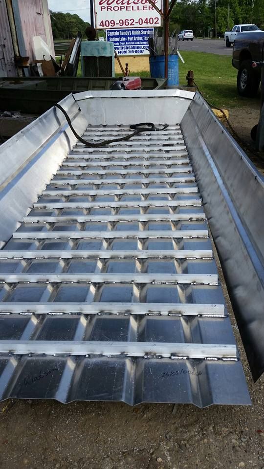 Aluminum boat bed frame with cross supports, outdoors.