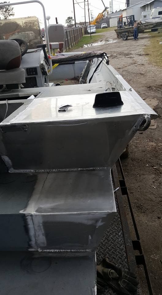 Aluminum boat with a closed compartment and other compartments visible.