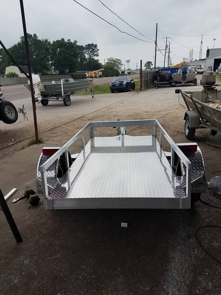 Aluminum utility trailer with diamond plate floor, ready for use.