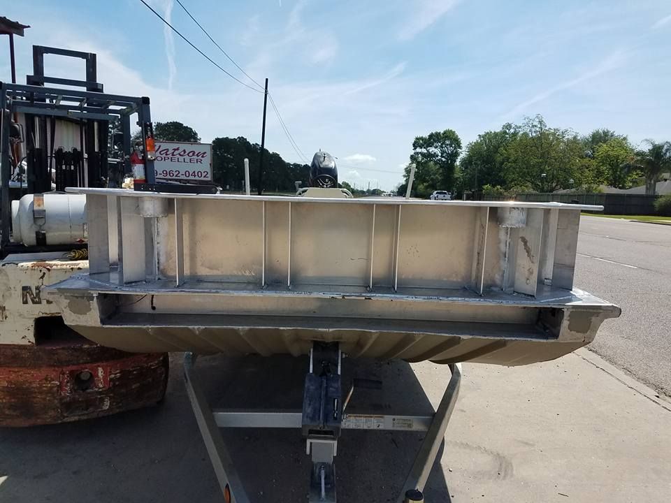 Aluminum boat hull on trailer, viewed from the rear, showing internal structural supports.