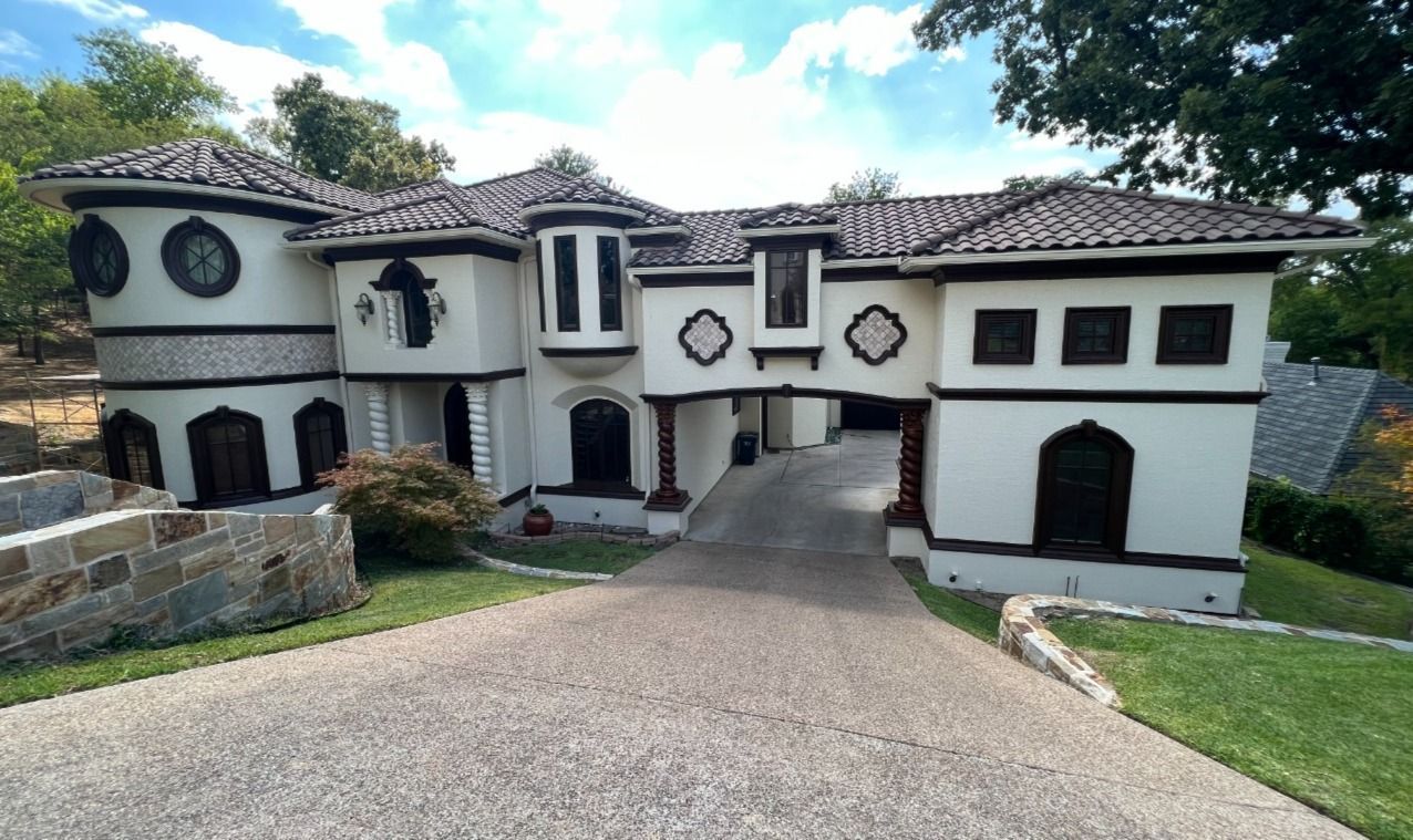 A large white house with a driveway leading to it