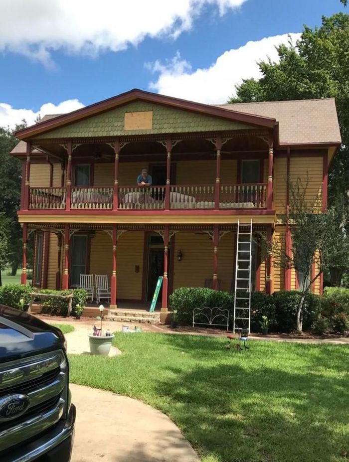 A large house with a car parked in front of it.