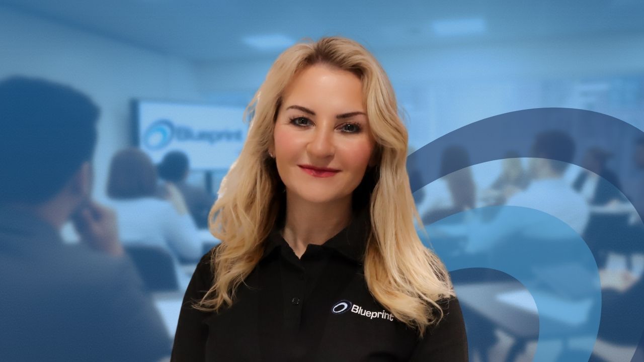 Woman smiling, identified as Avril, Head of Blueprint. The blue text overlay reads, 