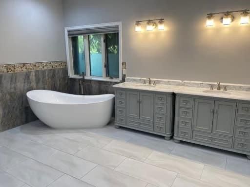 whole bathroom renovation with a freestanding tub and shower