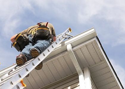 Man On A Ladder Fixing Gutter — Island Park, NY — Eveready Roofing Co.