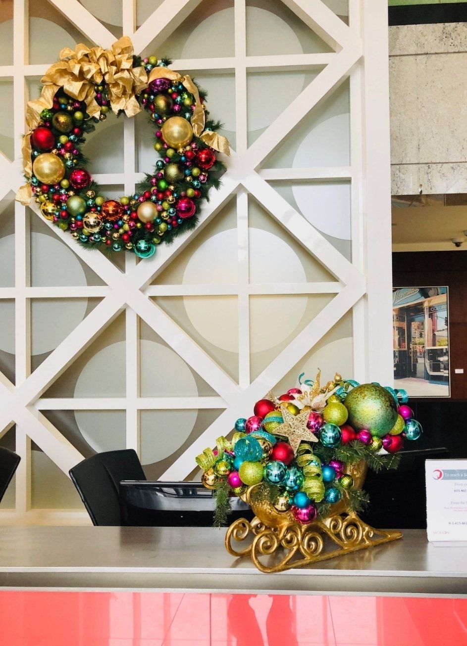 a christmas wreath is hanging on a wall above a desk