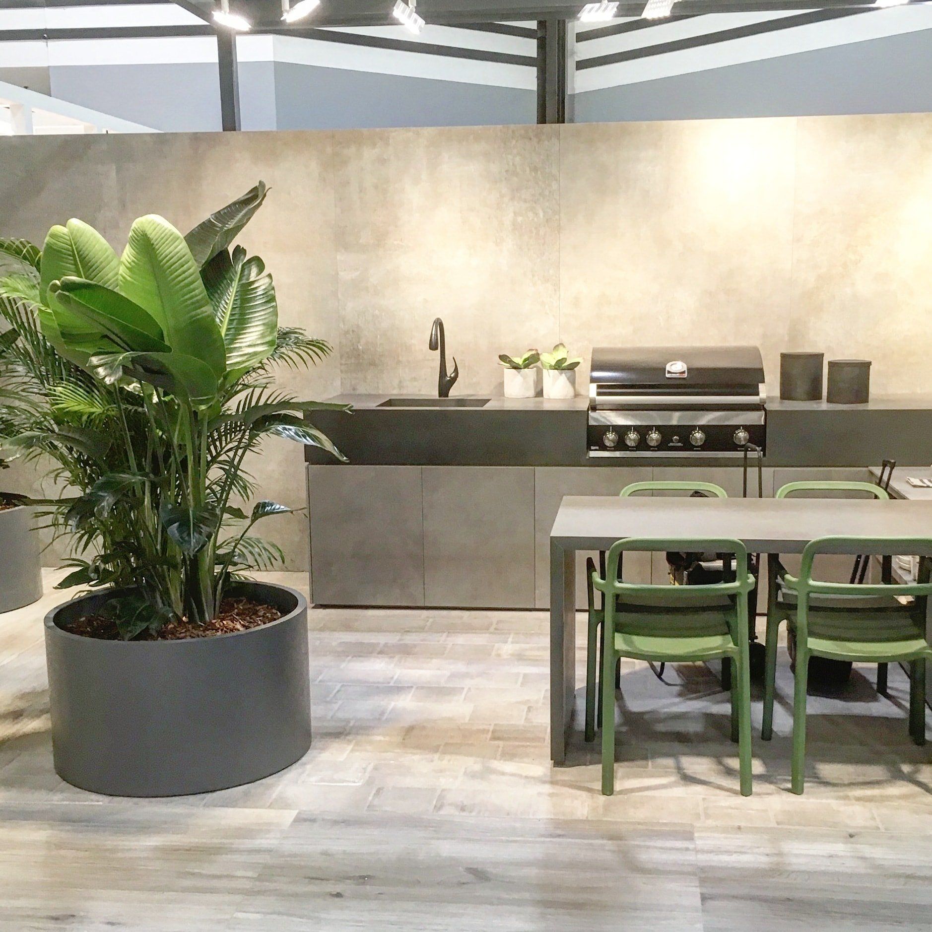 a kitchen with a table and chairs and a potted plant