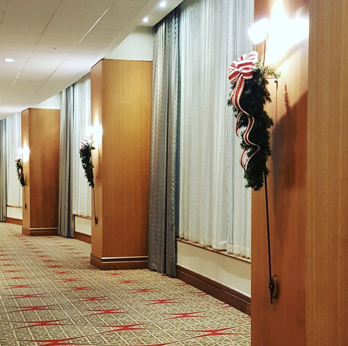 a long hallway with christmas decorations on the walls