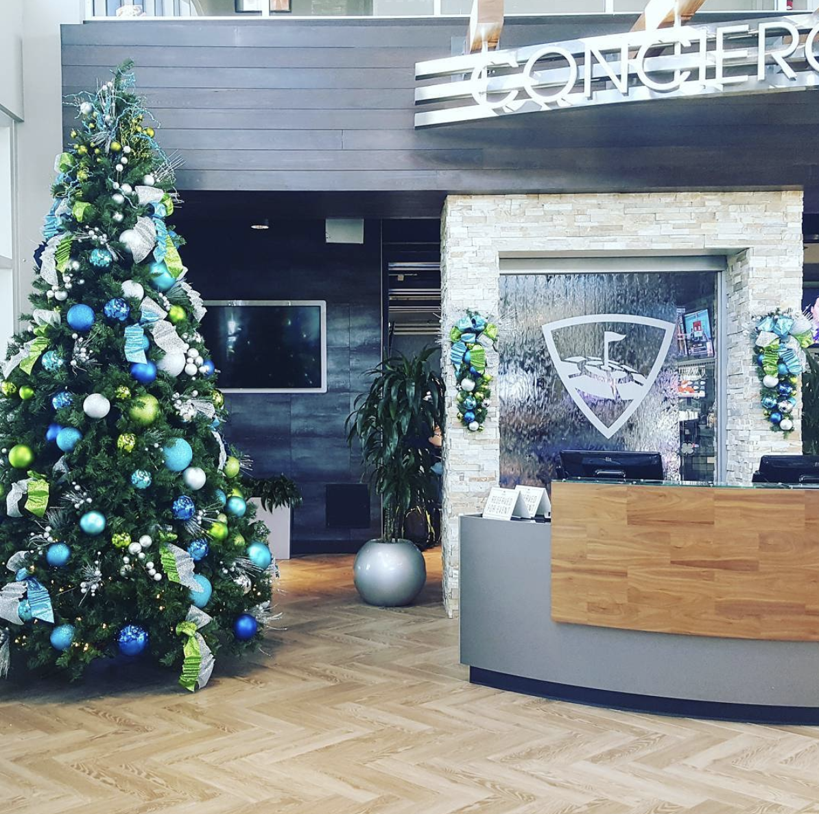 a christmas tree in front of a sign that says concierge