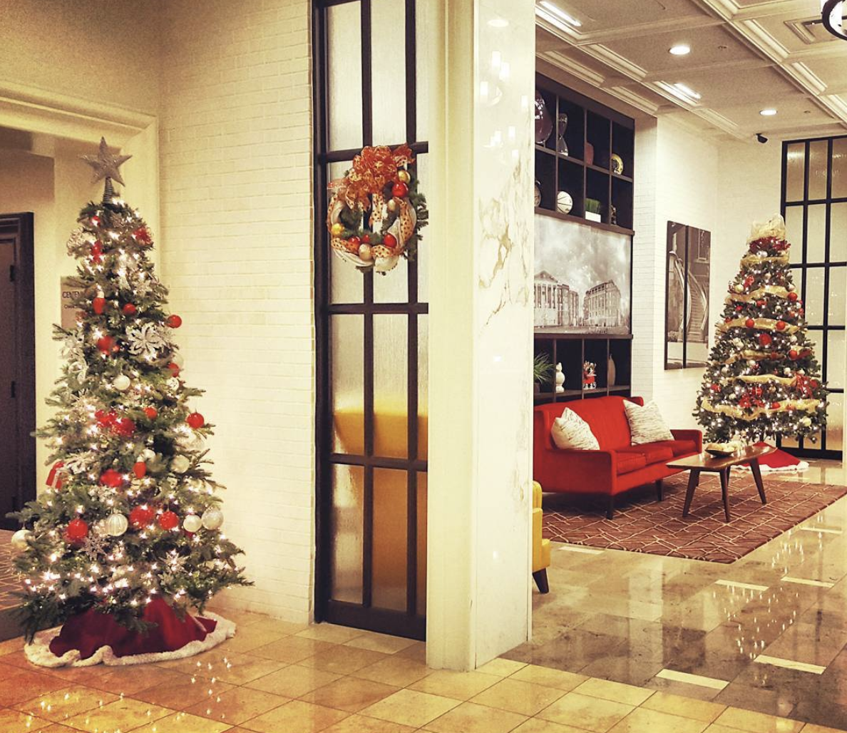 a living room with a christmas tree and a red couch