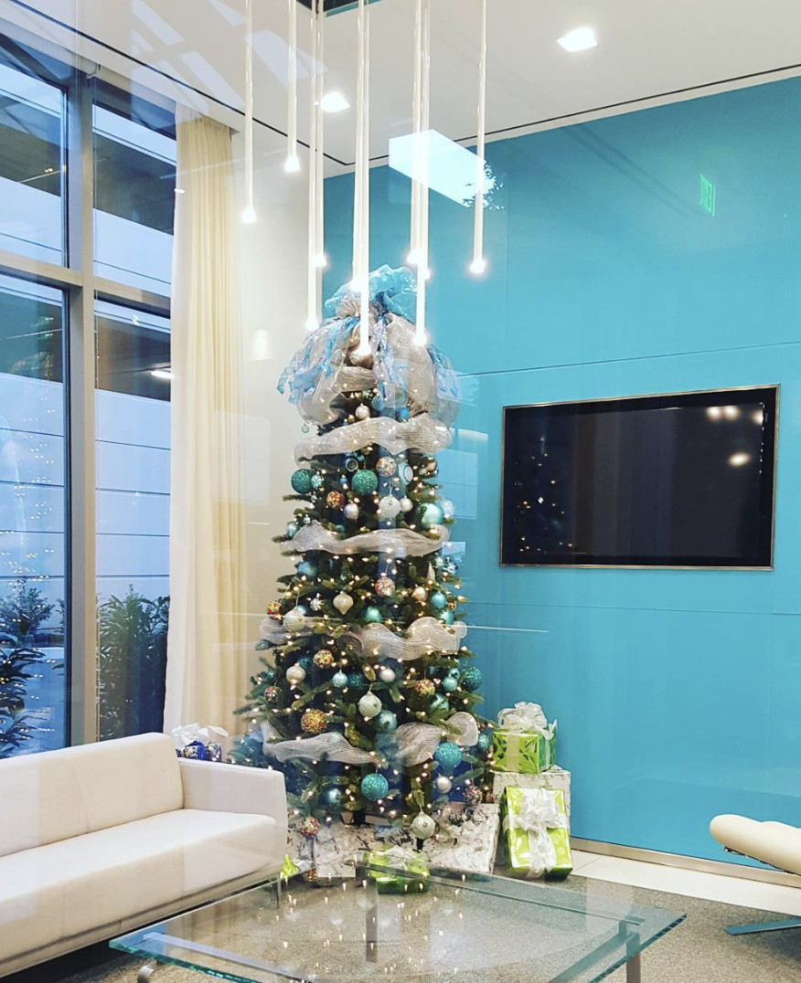 a living room with a couch and a christmas tree