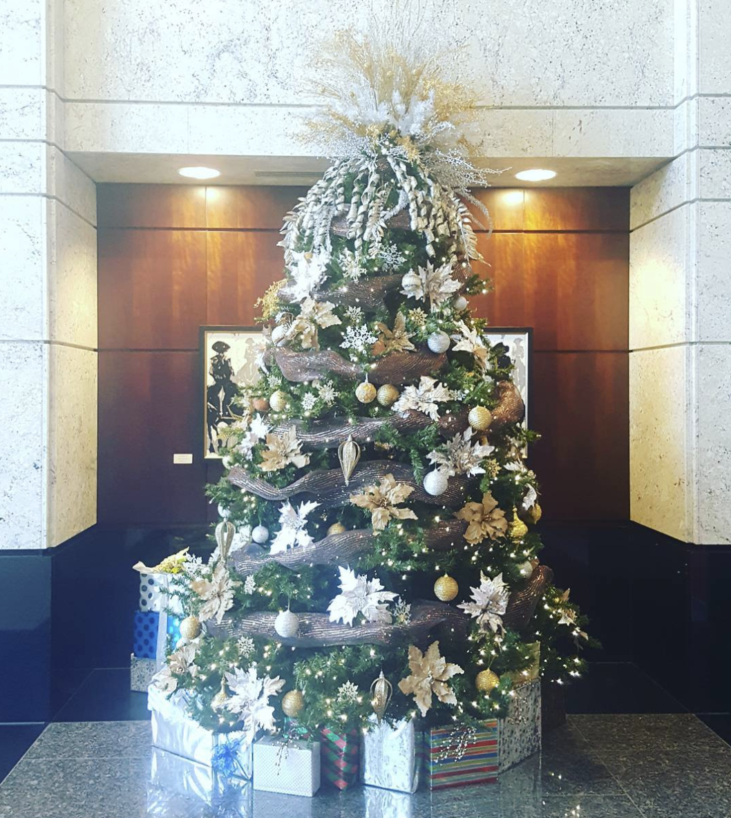 a large christmas tree is sitting in the middle of a room