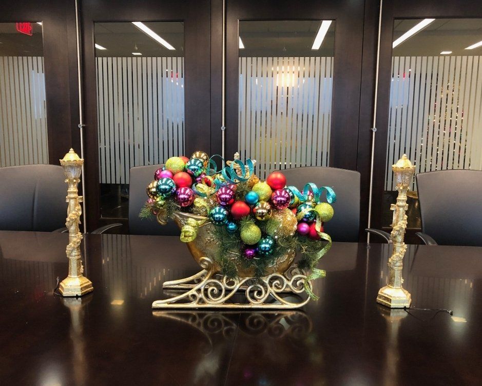 a sleigh filled with christmas decorations sits on a table