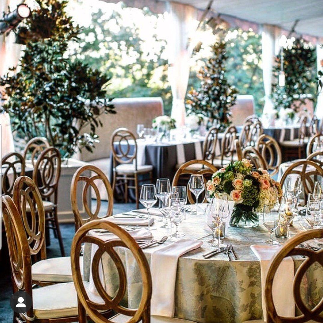 a dining room with tables and chairs set up for a wedding reception