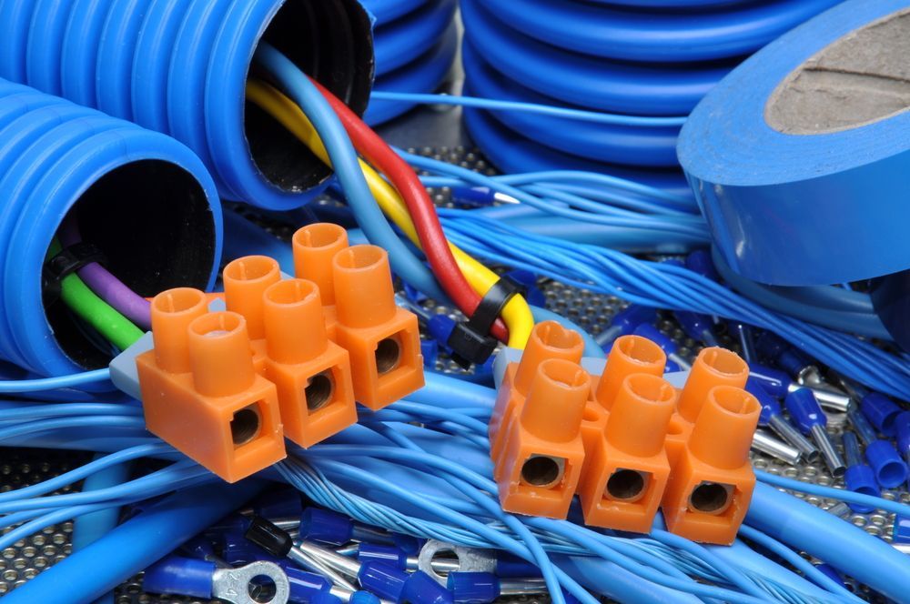 Blue electrical conduits, wiring, orange terminal blocks — AC/DC Electrical, Air Conditioning & Refrigeration In Zilzie, QLD