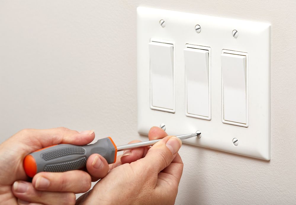 Hands Use a Screwdriver to Remove a Screw — AC/DC Electrical, Air Conditioning & Refrigeration In Plainlands, QLD