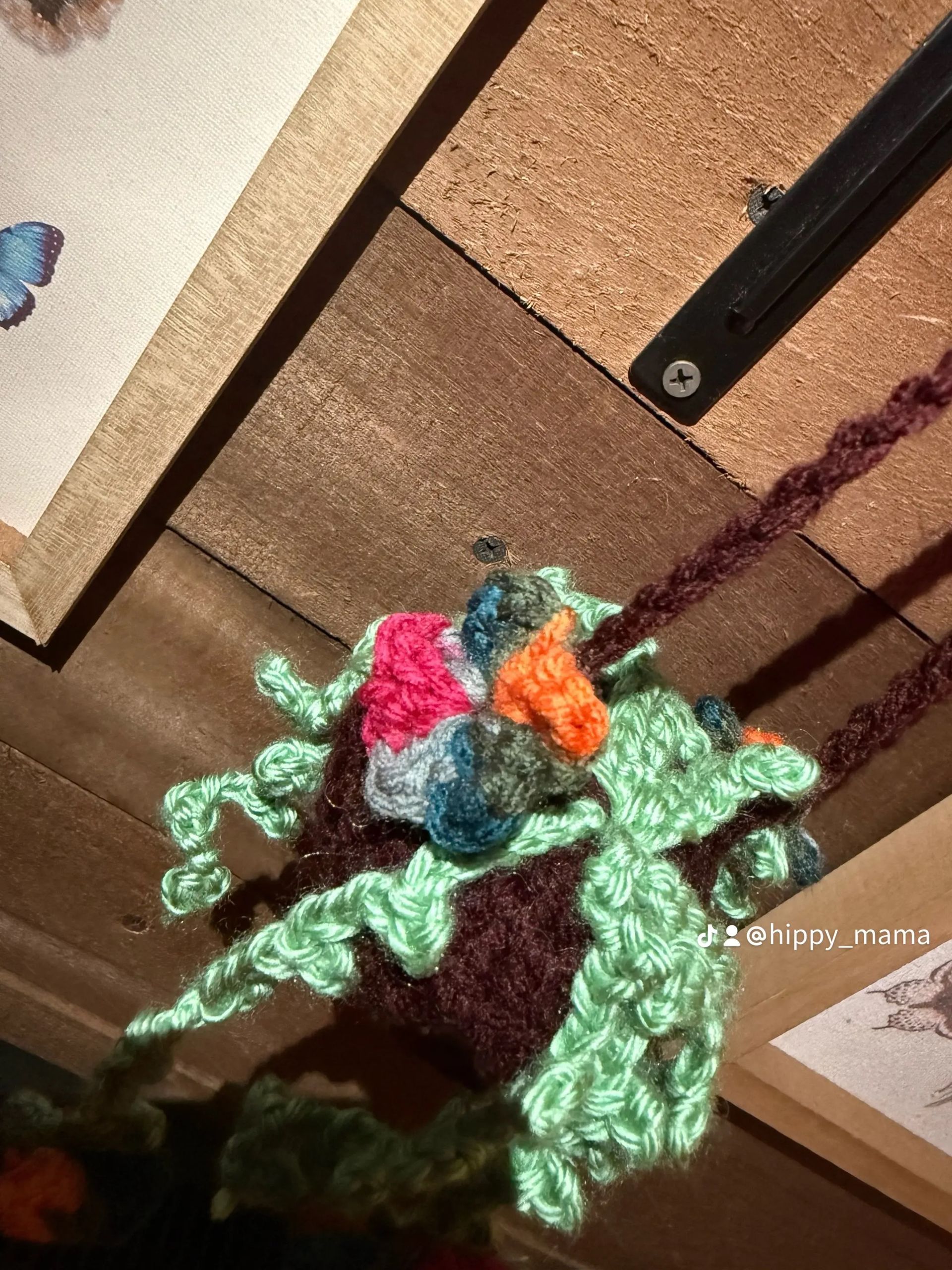 HANGING PLANT W/PURPLE POT & VERIGATED FLOWERS